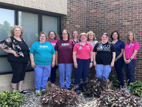 Pictured is Horn's Home Health staff members. They are standing outside smiling shoulder to shoulder in a garden.