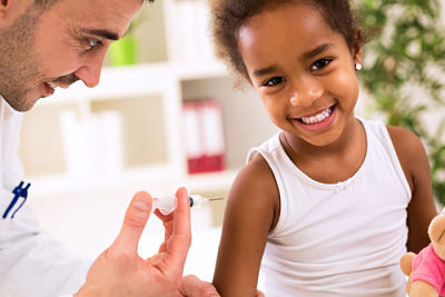 Male Physician giving a little girl a shot