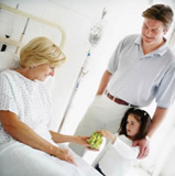 Female patient is being visited by her granddaughter and son