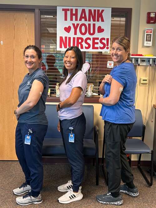 Pictured is three of Horn Memorial's diabetes eduction staff members. They are standing in a hallway with a sign behind them that reads "Thank You Nurses".