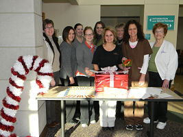 Service Excellence Team standing behind a table for a group picture