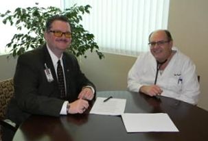 Newest provider, Curtiss Farrell, MD and another male provider smiling