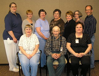 Horn Hospice Staff smiling. There is eight females and two males smiling