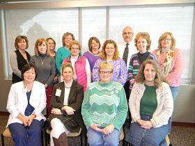 Group of Ida County Community Alliance, smiling. There is thirteen females and one male.
