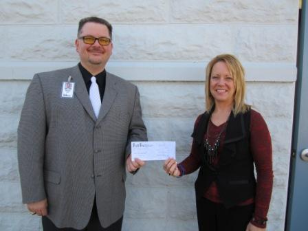 CEO, Marc Augsburger standing next to Superintendent, Dani Trimble. They are both holding the check